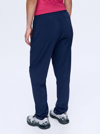 Model seen from back wearing Zephyr 29" Pant in Navy, featuring elastic waistband for comfort.