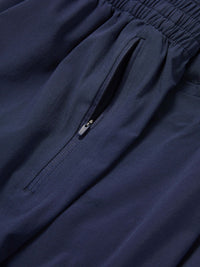Close-up of Zephyr 29" Pant in Navy, highlighting the zippered pocket for secure storage.
