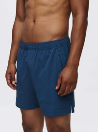 Model wearing Zephyr 5" Short in Navy, with zippered pockets and a custom-fit drawstring waist.
